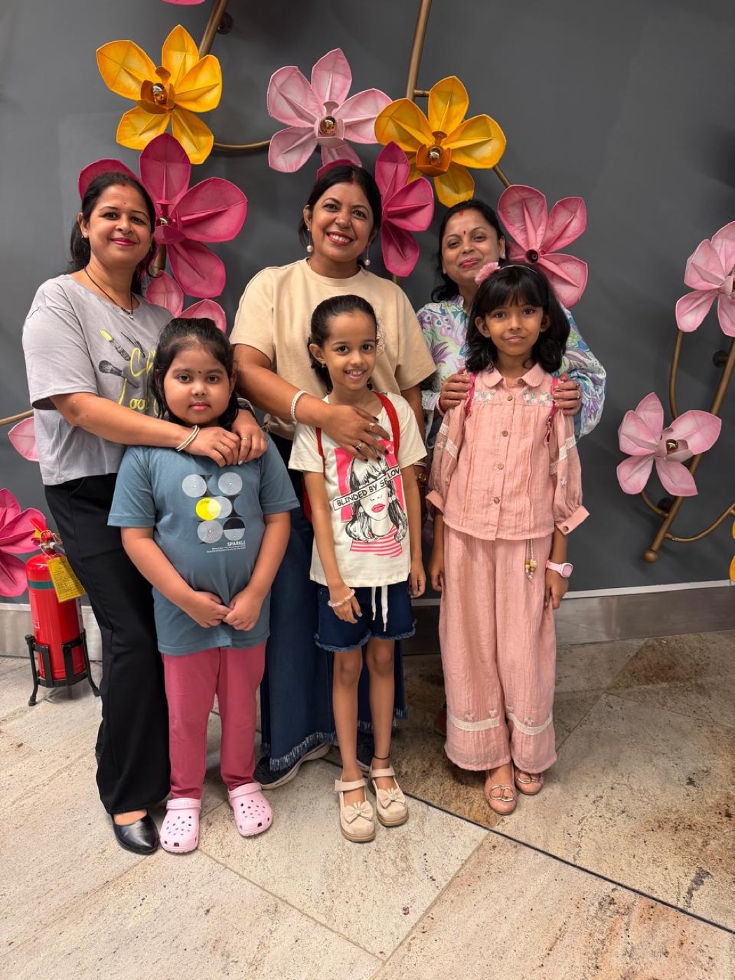 Three women and three children together on an AXOM departure