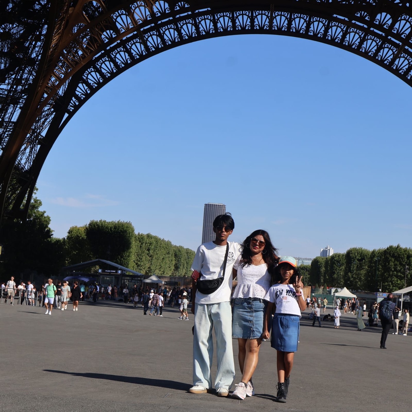 A mother and two children beneath the Eiffel Tower, Paris