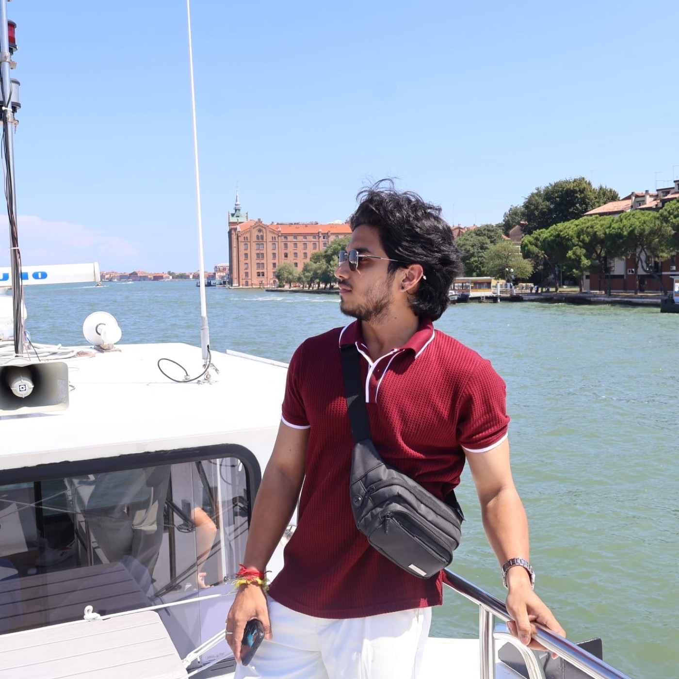 A traveller looking out across the lagoon from a boat, Venice